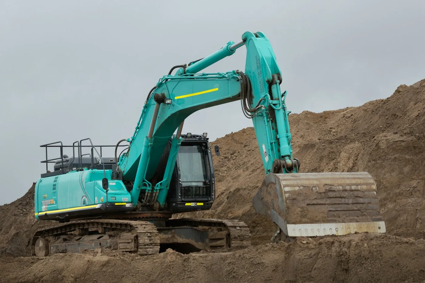 Tracked excavator on a mound of soil